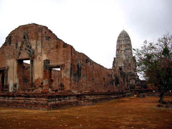 Roofless ruin with Buddha Stupa behind it