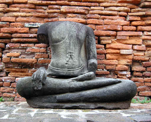 A headless Buddha statue pays tribute to the past, Ayutthaya, Thailand