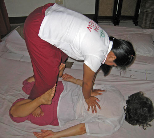 An awkward position, but brings benefits. Thai massage, Chiang Mai, Thailand