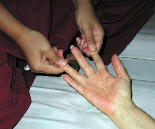 Snapping negative energy out of Akaisha's hands. Thai massage, Chiang Mai, Thailand