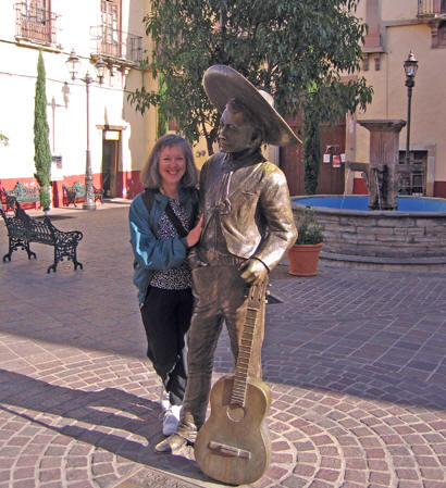 Akaisha next to a bronze musician friend, Guanajuato, Mexico