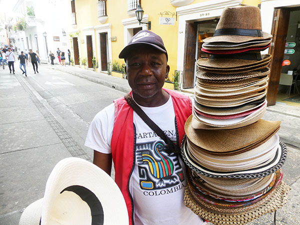 A hat vendor in the streets of the walled city of Cartagena, Colombia
