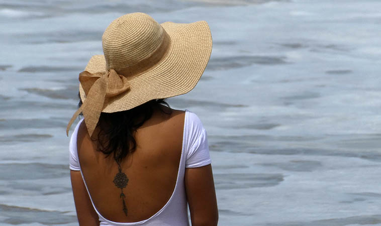 An artistic shot of female hat wearer on the  beach, Chacala,  Mexico