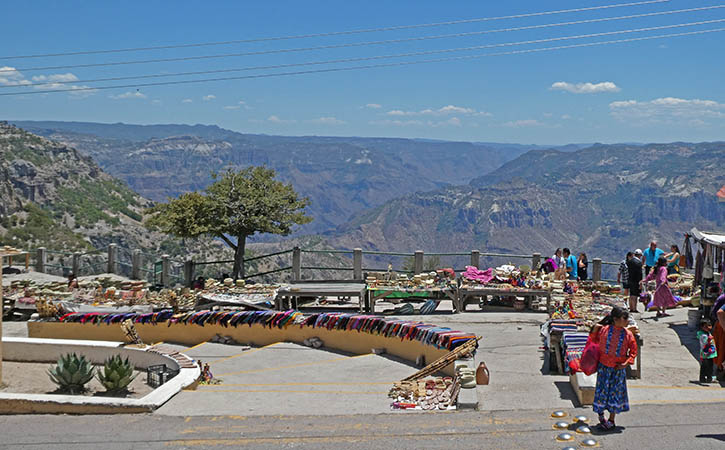 Indigenous weavings a crafts spread out over tables and benches Copper Canyon, Divisidero, Mexico El Chepe Train