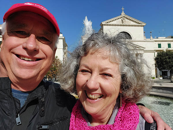 Older couple in front of a fountain in Italy