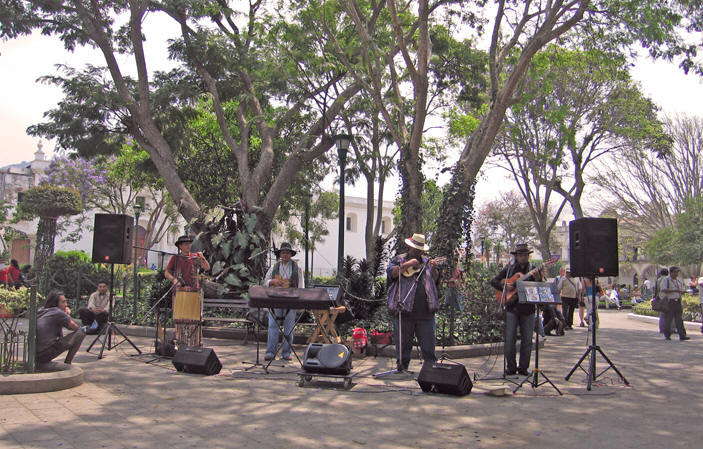 Peruvian musicians playing for tips, selling their CD's