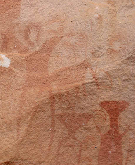 A spray painting of  hands (the artist's signature?) and more prehistoric animals. Pha taem caves, Thailand