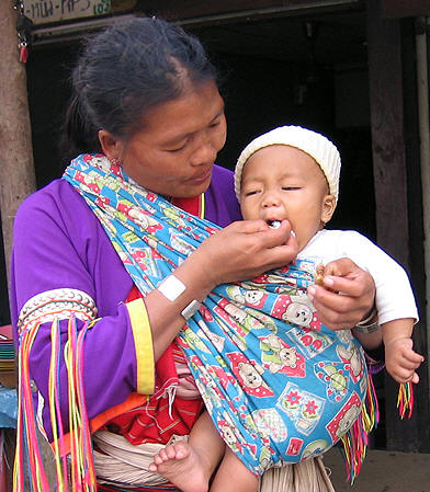 Rice is a staple all over Asia. This proud and devoted mother hand feeds her healthy child.