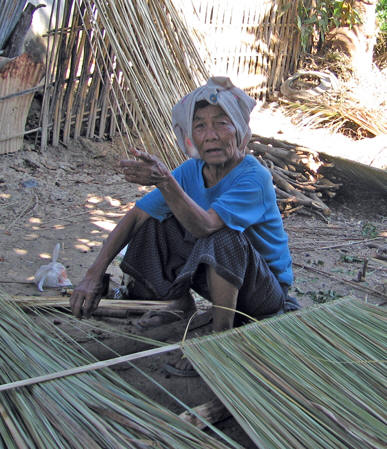 This village elder is making the roof thatching
