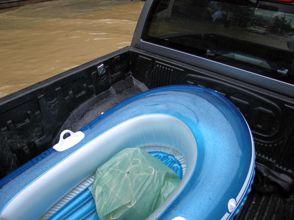 Billy is now in a pickup, with an inflatable boat in the back.  Chiang Mai Floods, Thailand