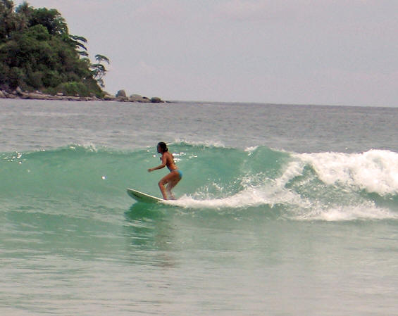 Surfing clear waters at Kata Beach, Thailand
