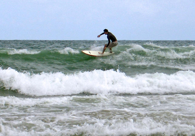 Surfer on waves at Kata Beach, Thailand