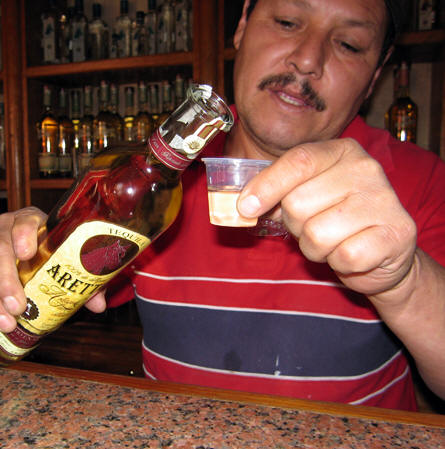 Rafael from El Llano distillery pours us a sample of  a prized reposado